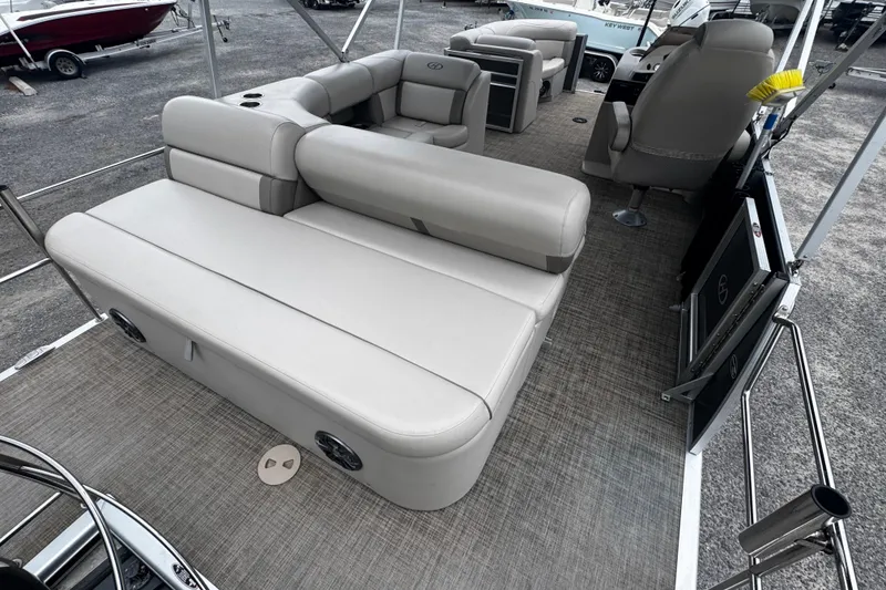 Slide: The Image of 2020 Harris Cruiser 210 pontoon boat interior with beige seating and spacious layout. - 6