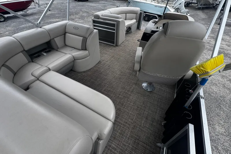 Slide: The Image of Interior of a 2020 Harris Cruiser 210 pontoon boat with plush seating and helm. - 7