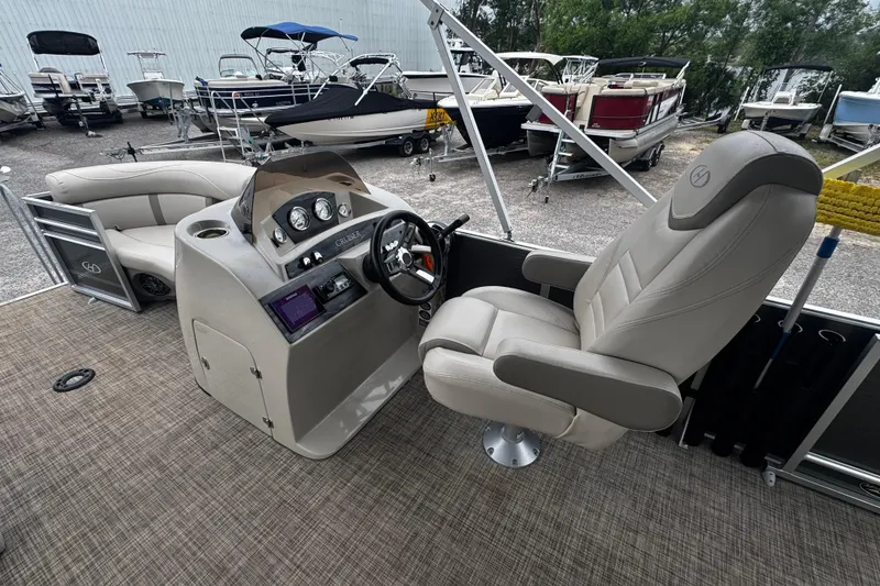 Slide: The Image of 2020 Harris Cruiser 210 boat interior with captain's chair and control panel. - 8
