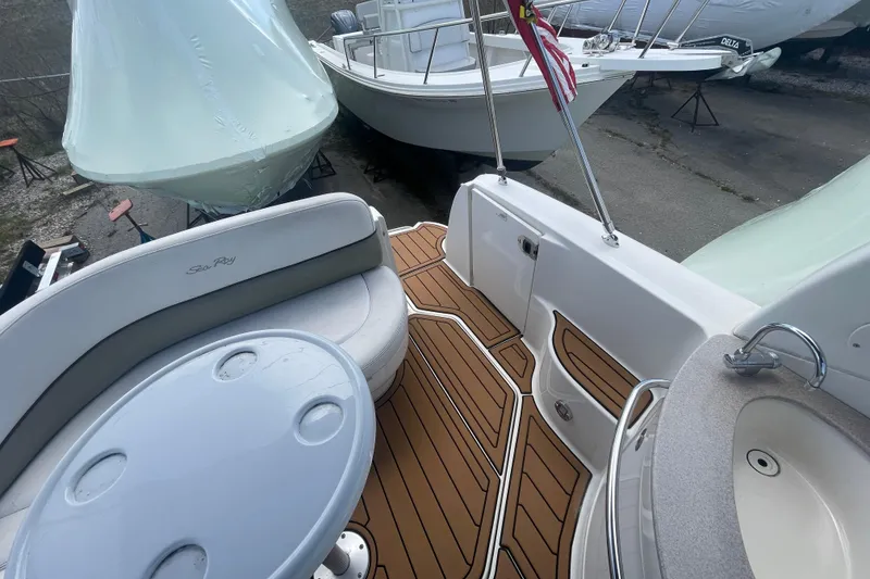 Slide: The Image of 2007 Sea Ray Sundancer 260 boat interior with seating, table, and American flag. - 10