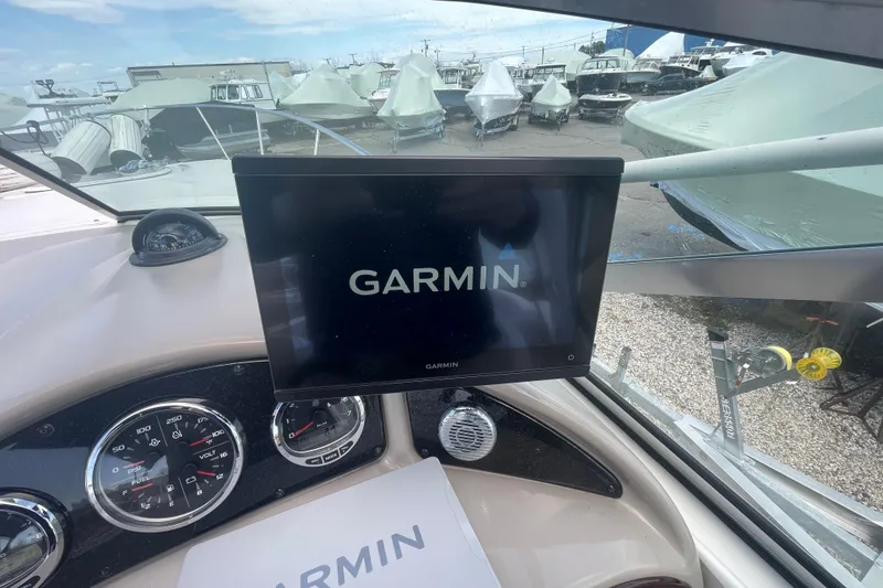 Slide: The Image of Garmin display on 2007 Sea Ray Sundancer 260 dashboard, surrounded by covered boats. - 18