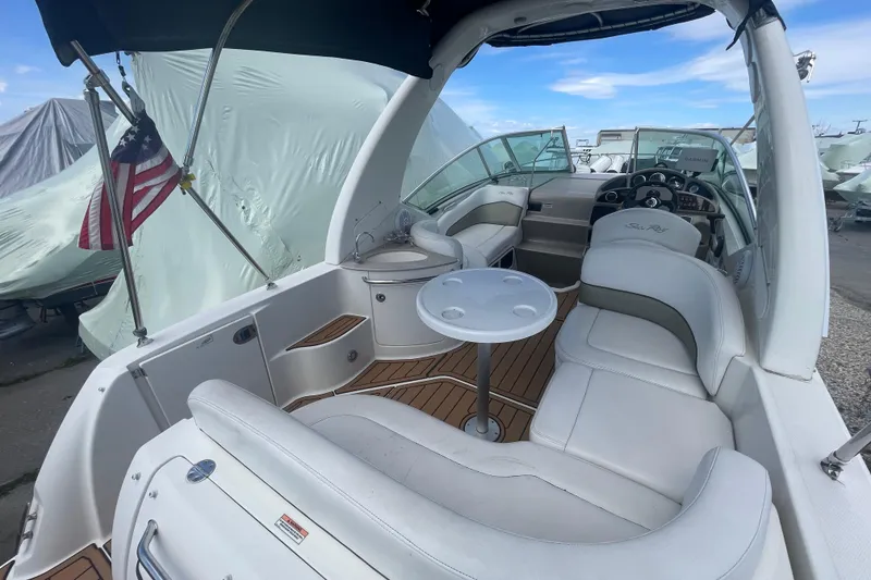Slide: The Image of 2007 Sea Ray Sundancer 260 boat interior with seating, table, and American flag. - 6
