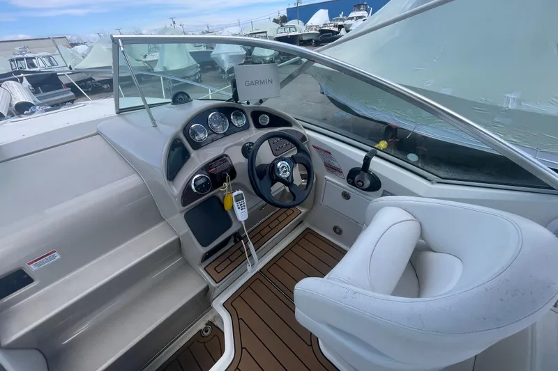 Slide: The Image of 2007 Sea Ray Sundancer 260 cockpit with steering wheel, gauges, and Garmin navigation system. - 9