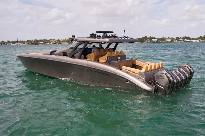 Slide: The Image of 2026 Midnight Express 52 Vitesse luxury boat cruising on clear blue water. - 15