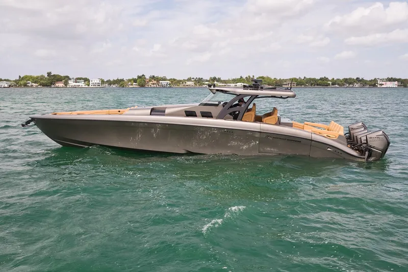 Slide: The Image of 2026 Midnight Express 52 Vitesse luxury boat on clear blue water. - 19