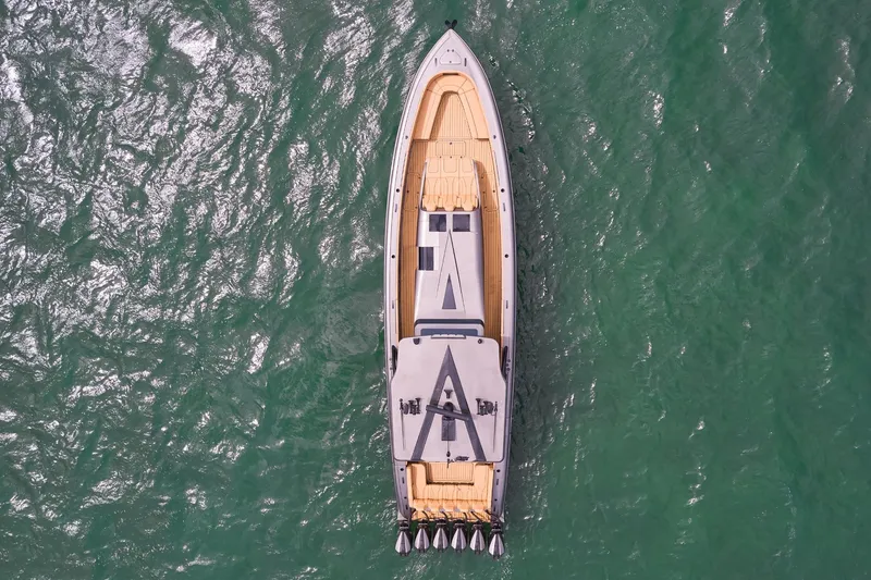 Slide: The Image of Aerial view of 2026 Midnight Express 52 Vitesse yacht on green water. - 21