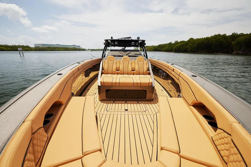 Slide: The Image of Luxurious 2026 Midnight Express 52 Vitesse boat with elegant tan seating on calm water. - 25