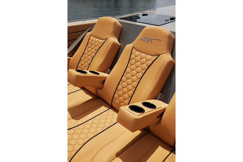 Slide: The Image of Luxurious tan leather seats on 2026 Midnight Express 52 Vitesse boat, featuring cup holders. - 27