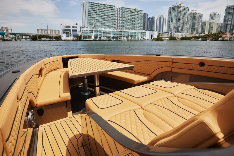 Slide: The Image of Luxurious 2026 Midnight Express 52 Vitesse yacht interior with tan seating and city skyline view. - 29
