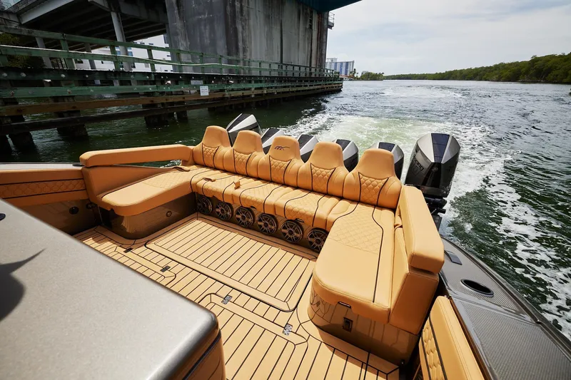 Slide: The Image of Luxurious seating on 2026 Midnight Express 52 Vitesse boat, cruising under a bridge. - 35