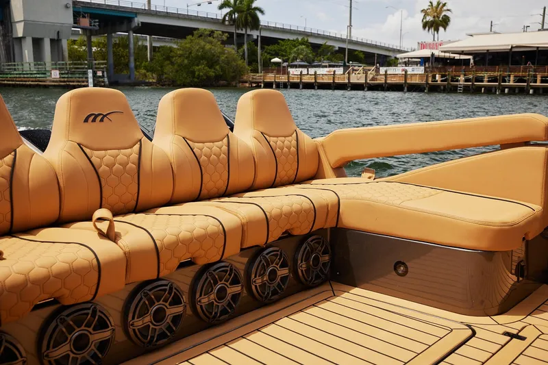 Slide: The Image of Luxurious seating on 2026 Midnight Express 52 Vitesse boat, featuring tan upholstery and stylish design. - 38