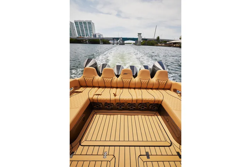 Slide: The Image of Luxury 2026 Midnight Express 52 Vitesse boat cruising on water, showcasing elegant seating and powerful engines. - 41