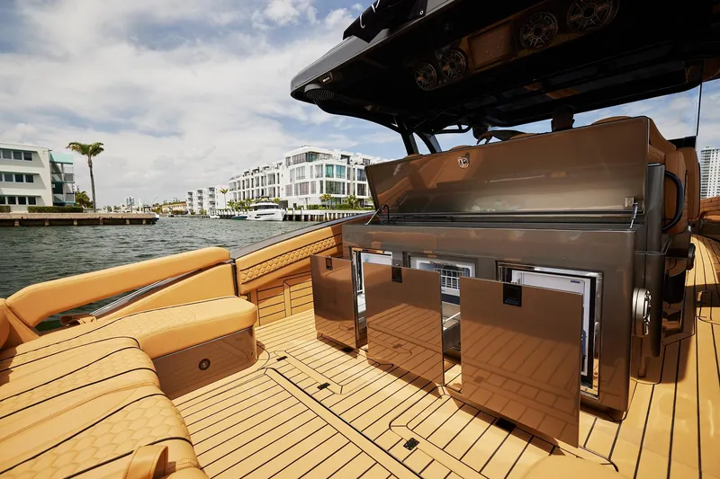 Slide: The Image of Luxurious 2026 Midnight Express 52 Vitesse yacht interior with modern amenities, docked near waterfront homes. - 42