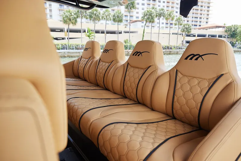 Slide: The Image of Luxurious tan leather seats in the 2026 Midnight Express 52 Vitesse boat. - 49