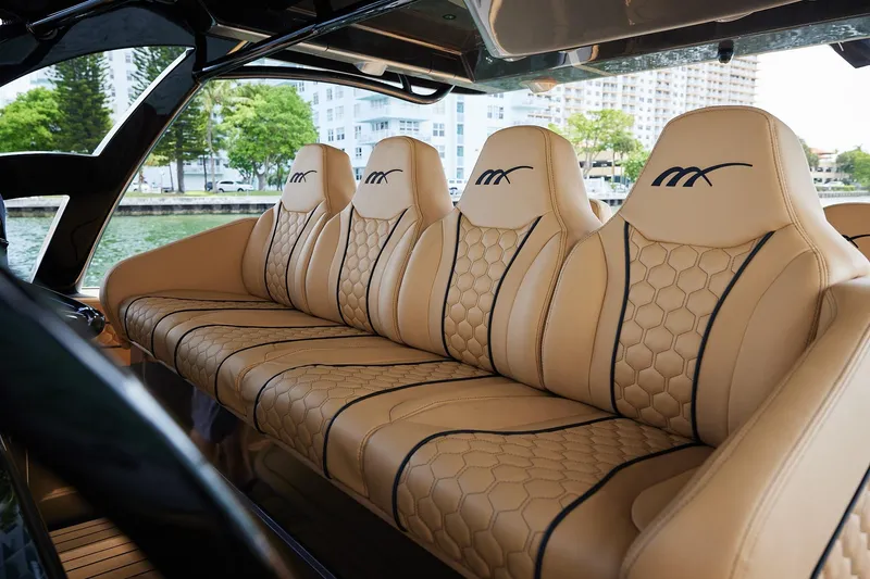Slide: The Image of Luxurious tan leather seating in 2026 Midnight Express 52 Vitesse boat interior. - 51