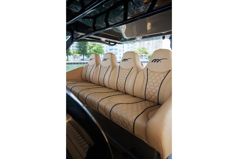 Slide: The Image of Luxurious seating in 2026 Midnight Express 52 Vitesse boat, featuring elegant beige upholstery. - 52