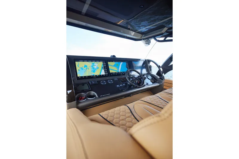 Slide: The Image of Luxurious helm of 2026 Midnight Express 52 Vitesse with advanced navigation displays. - 54