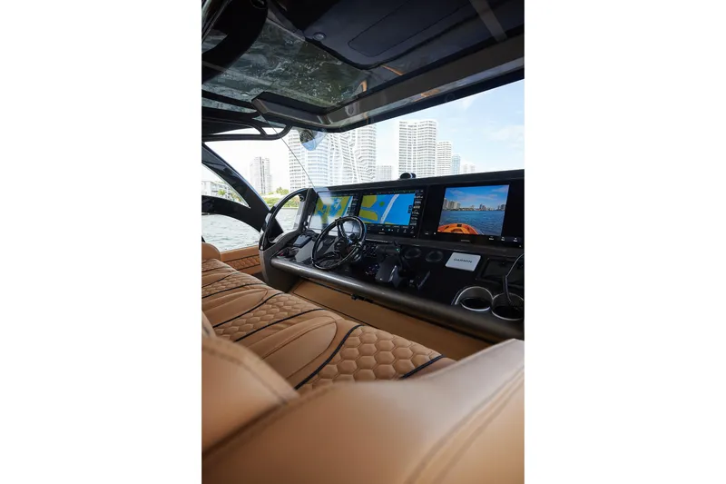 Slide: The Image of Luxurious cockpit of 2026 Midnight Express 52 Vitesse yacht with advanced navigation displays. - 56