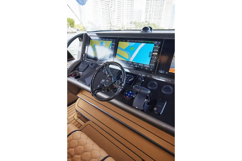 Slide: The Image of Helm of 2026 Midnight Express 52 Vitesse with advanced navigation displays and controls. - 59