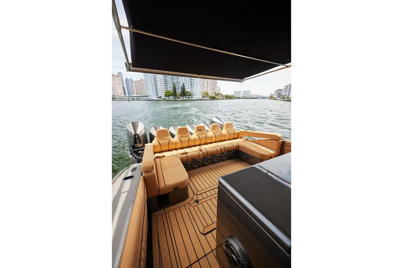Slide: The Image of Luxurious 2026 Midnight Express 52 Vitesse yacht interior with tan seating and scenic waterfront view. - 63