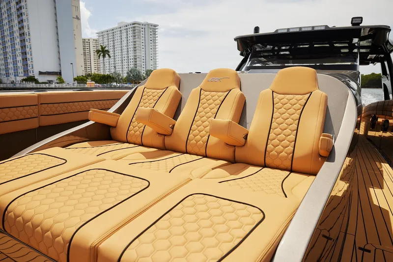 Slide: The Image of Luxurious tan seating on 2026 Midnight Express 52 Vitesse boat, with modern design and cityscape backdrop. - 70