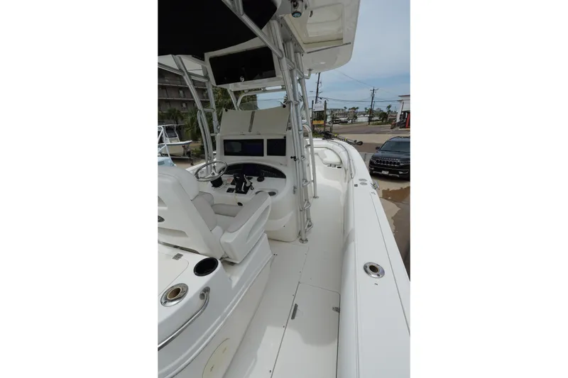 Slide: The Image of 2004 Boston Whaler 320 Outrage boat interior with steering console and seating. - 12