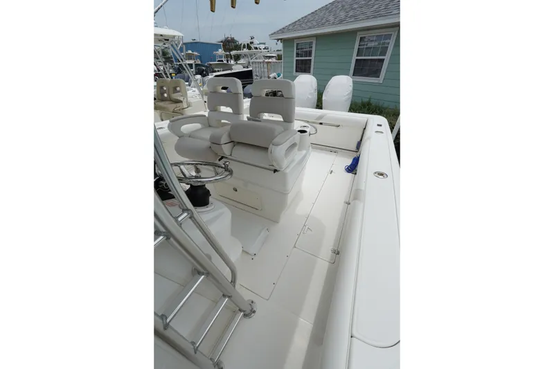 Slide: The Image of 2004 Boston Whaler 320 Outrage boat interior with seating and steering wheel. - 13