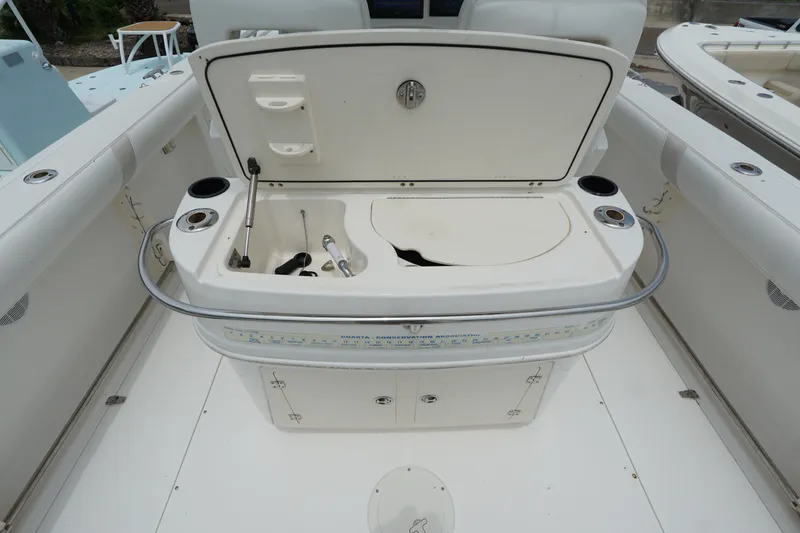 Slide: The Image of 2004 Boston Whaler 320 Outrage boat interior with open storage compartment. - 14