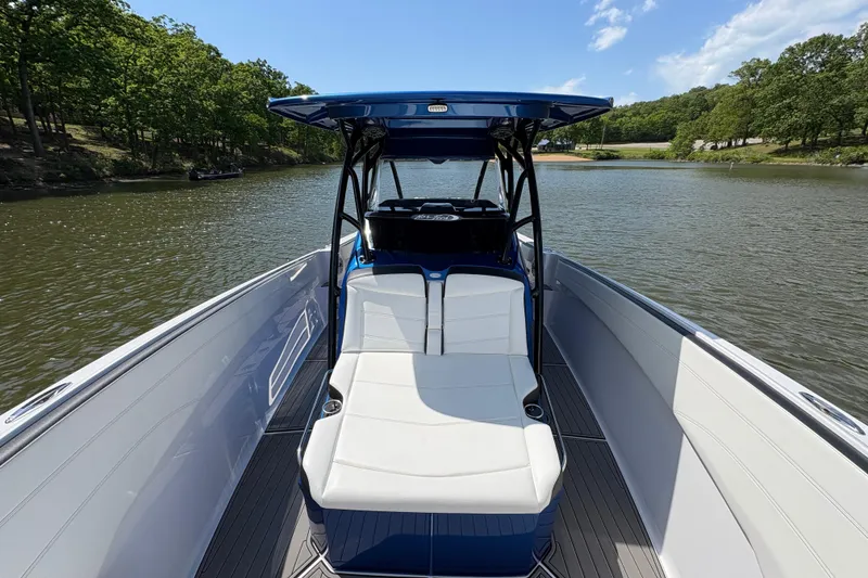 Slide: The Image of 2020 Nor-Tech 340 Sport Center Console boat on a serene lake. - 12