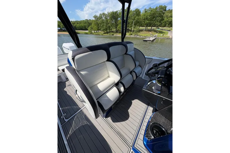 Slide: The Image of 2020 Nor-Tech 340 Sport Center Console boat interior with luxurious seating and scenic lake view. - 15
