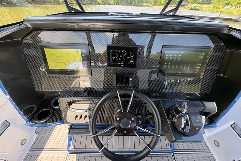 Slide: The Image of 2020 Nor-Tech 340 Sport Center Console dashboard with advanced navigation displays and controls. - 18