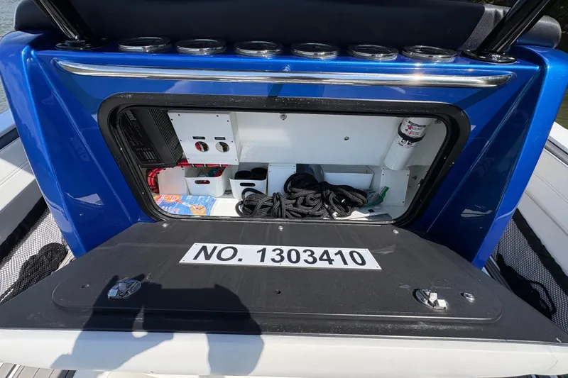 Slide: The Image of 2020 Nor-Tech 340 Sport Center Console storage compartment with equipment and ropes. - 22