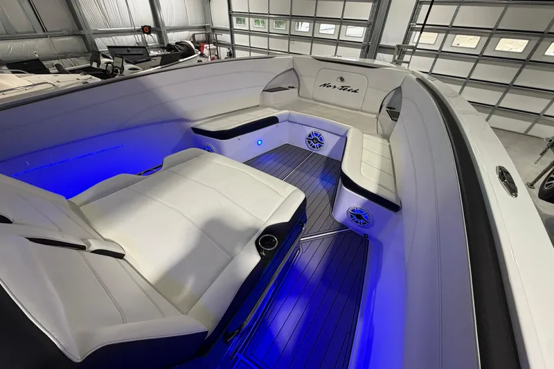 Slide: The Image of 2020 Nor-Tech 340 Sport Center Console interior with blue LED lighting and white seating. - 30