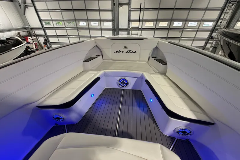 Slide: The Image of 2020 Nor-Tech 340 Sport Center Console interior with white seating and blue LED lighting. - 31