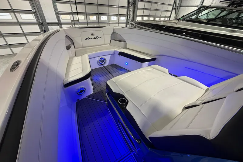 Slide: The Image of 2020 Nor-Tech 340 Sport Center Console interior with blue LED lighting and white seating. - 32
