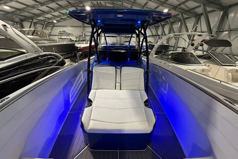Slide: The Image of 2020 Nor-Tech 340 Sport Center Console with blue LED lighting in a showroom. - 33