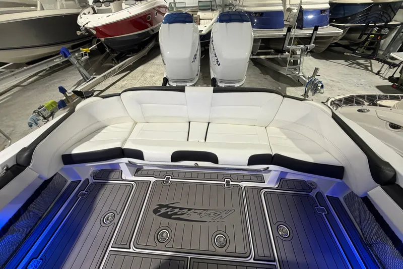 Slide: The Image of 2020 Nor-Tech 340 Sport Center Console with white seating and dual engines in a showroom. - 38