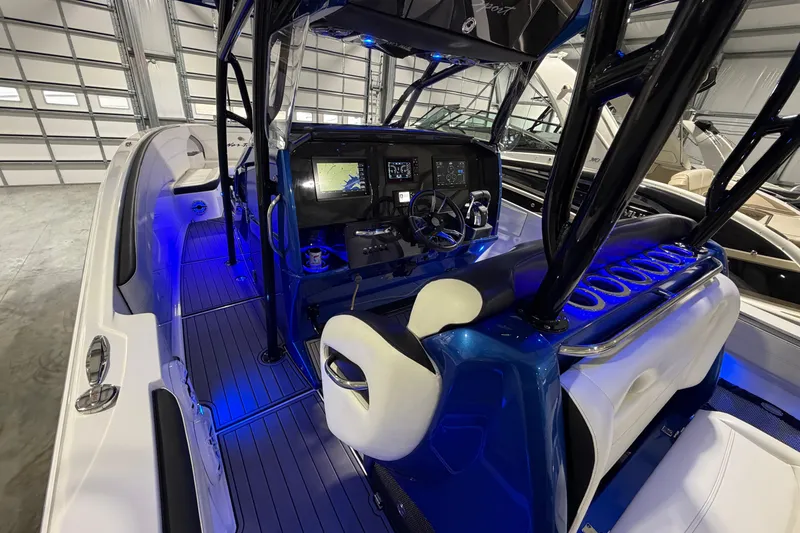 Slide: The Image of 2020 Nor-Tech 340 Sport Center Console boat interior with illuminated dashboard and seating. - 42
