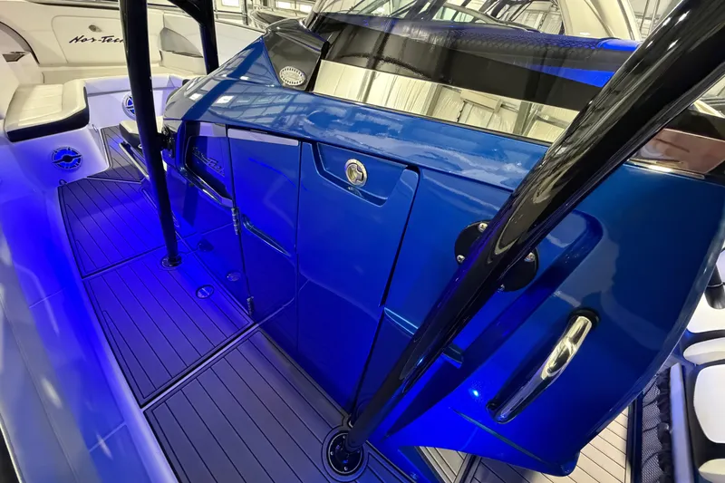 Slide: The Image of 2020 Nor-Tech 340 Sport Center Console with sleek blue design and illuminated deck. - 44
