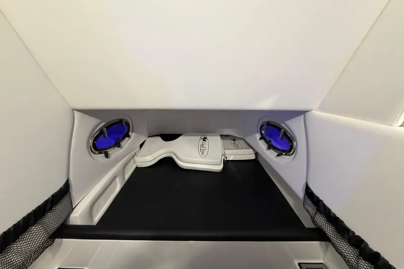 Slide: The Image of 2020 Nor-Tech 340 Sport Center Console cabin interior with portholes and storage. - 46