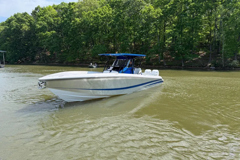 Slide: The Image of 2020 Nor-Tech 340 Sport Center Console boat cruising on a calm lake. - 7