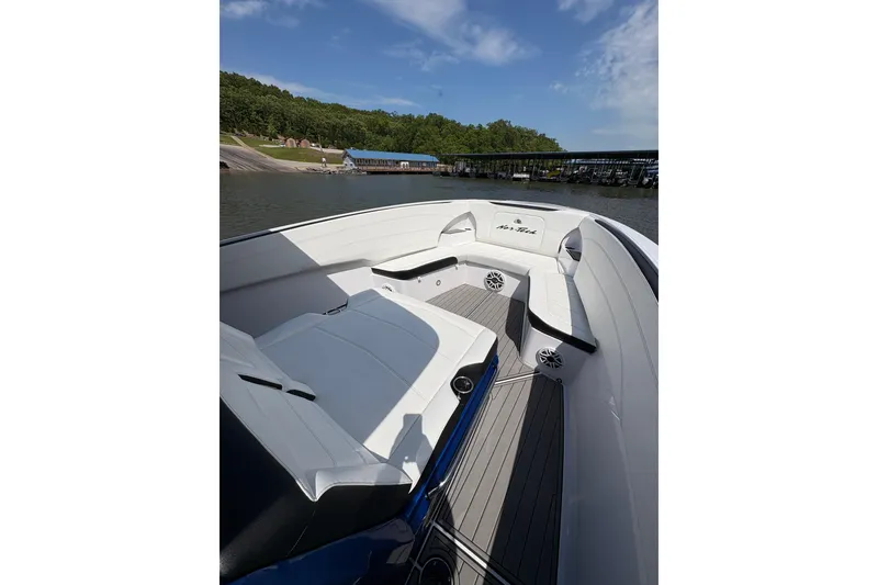Slide: The Image of 2020 Nor-Tech 340 Sport Center Console boat with sleek seating and modern design on a calm lake. - 8