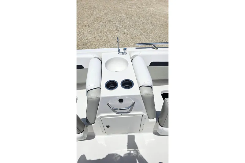 Slide: The Image of 2023 Starcraft SVX 211 OB boat interior with cup holders and storage compartment. - 15