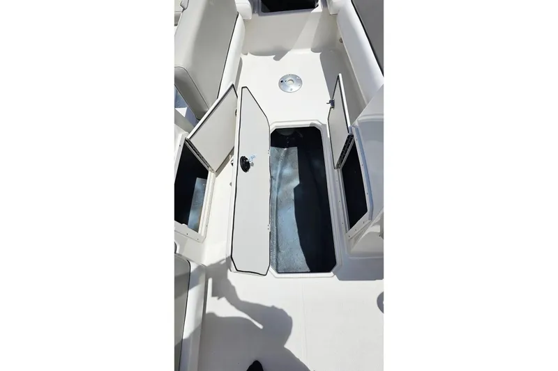 Slide: The Image of 2023 Starcraft SVX 211 OB boat interior with open storage compartments. - 17