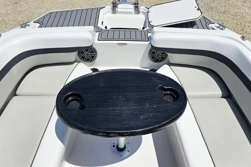 Slide: The Image of 2023 Starcraft SVX 211 OB boat interior with seating and a black table. - 5