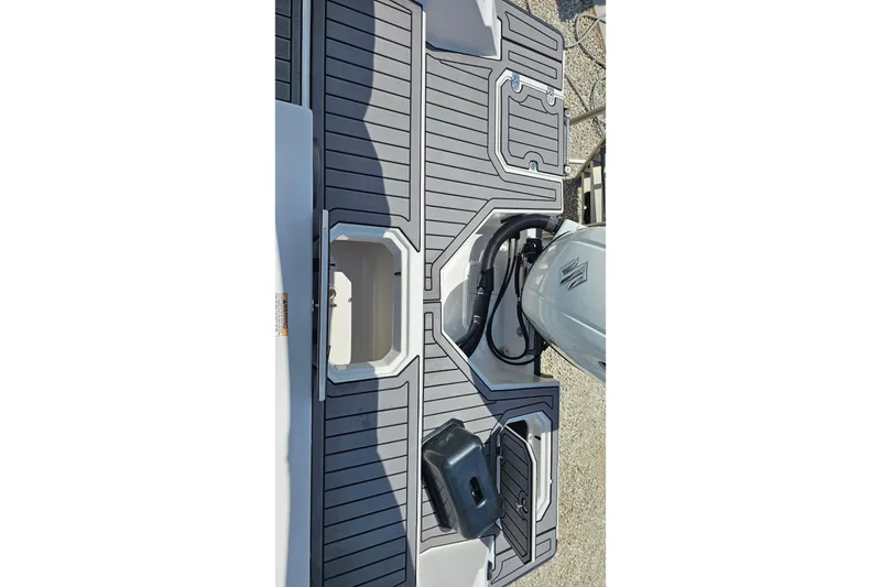 Slide: The Image of 2023 Starcraft SVX 211 OB boat deck with modern design and storage compartments. - 6