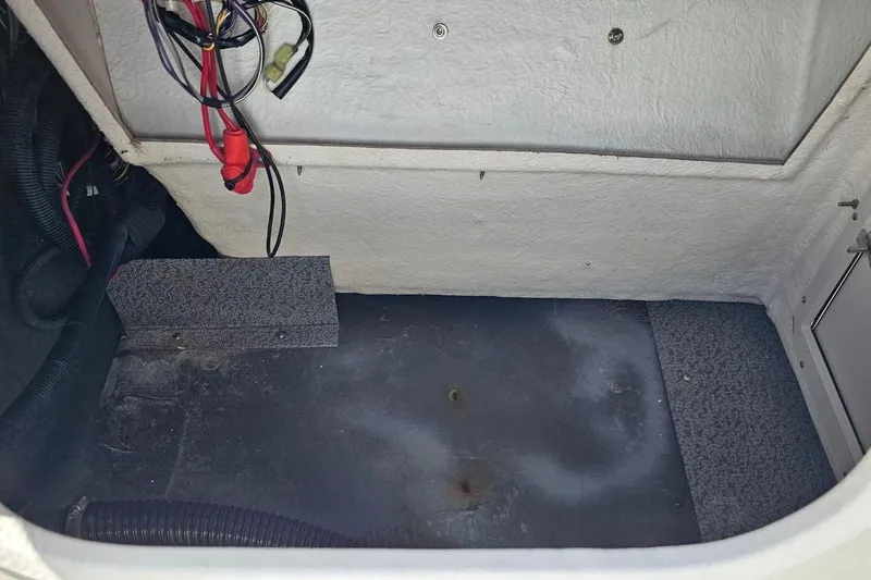Slide: The Image of 2023 Starcraft SVX 211 OB boat interior compartment with wiring and storage space. - 8