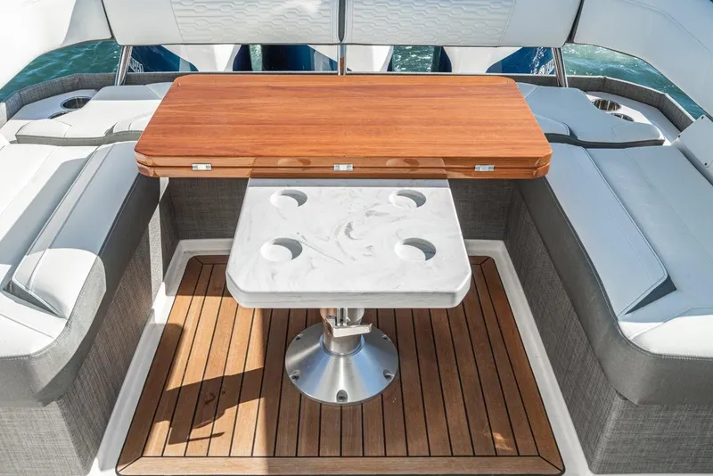 Slide: The Image of Interior of 2019 Tiara Yachts 38 LS with wooden table and seating area. - 33