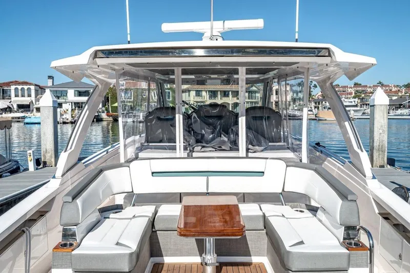 Slide: The Image of 2019 Tiara Yachts 38 LS with luxurious seating area at the harbor. - 41
