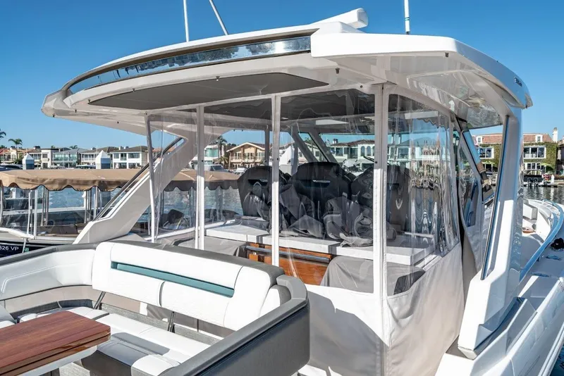 Slide: The Image of 2019 Tiara Yachts 38 LS with covered seating area in harbor. - 42